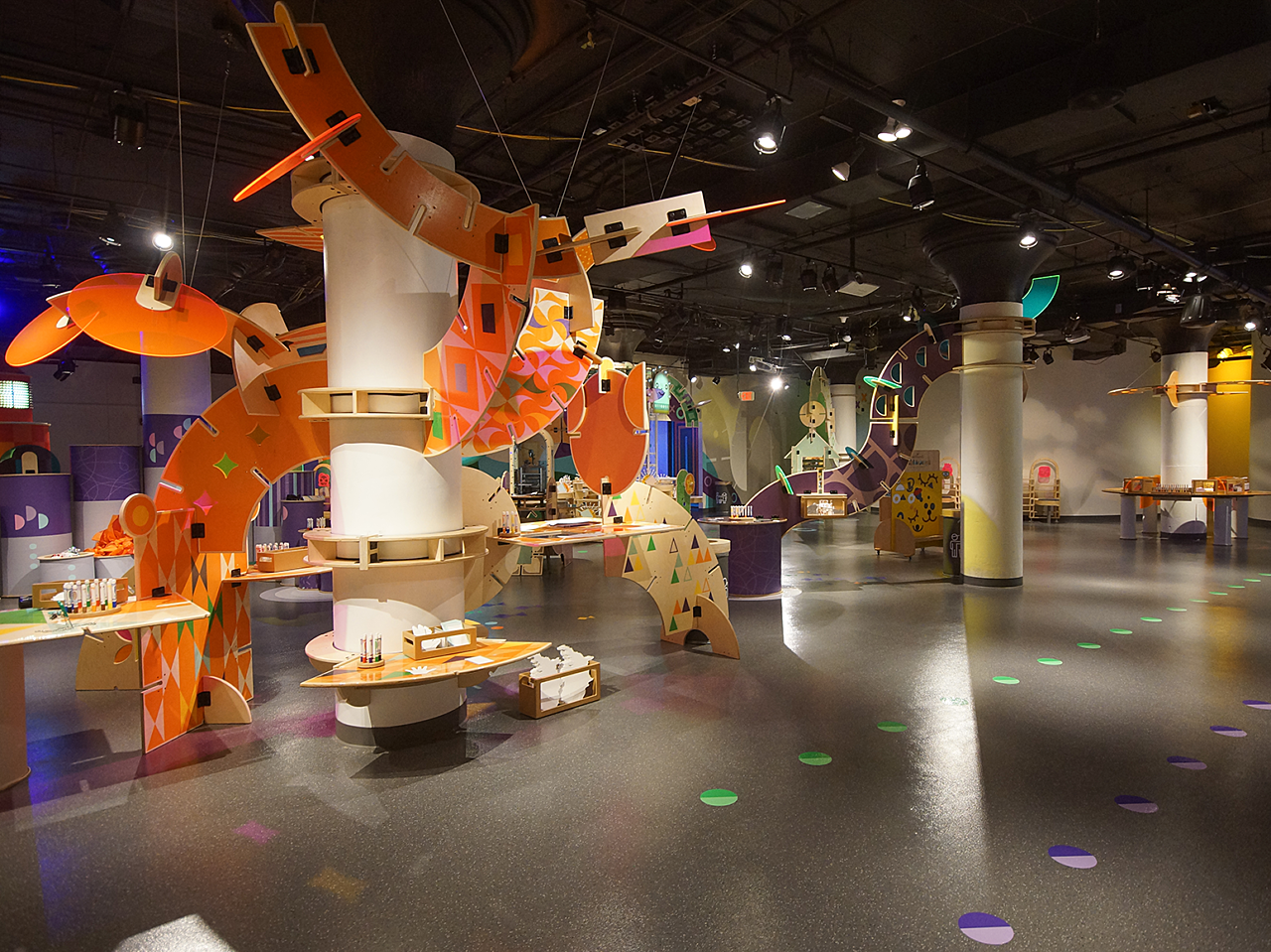 Hallmark Kaleidoscope art station with a tall mobile-like exhibit with orange slatted pieces flowing off of it.