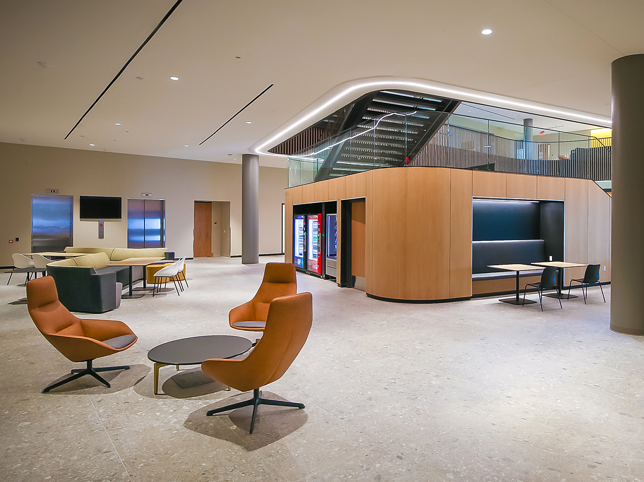 WSU's Woolsey Hall-Open area with nook, modular lounge sofa area with tables and brown lounge seating area with low black coffee table.