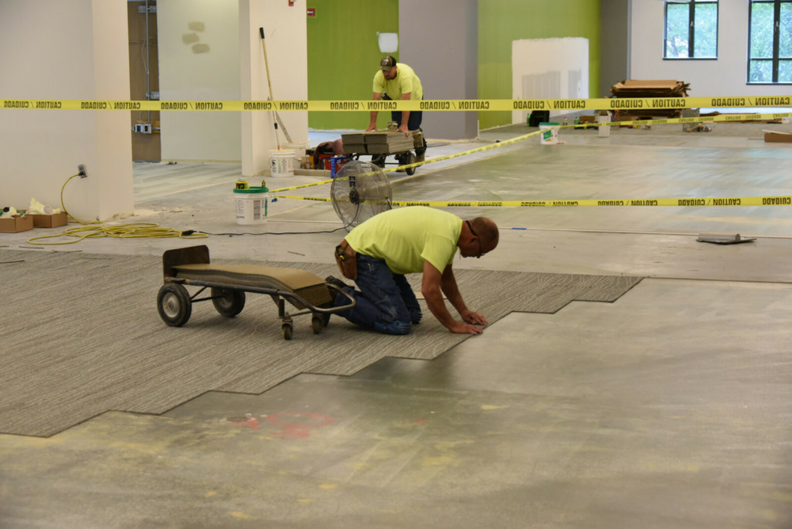 FDC installer laying carpet tiles