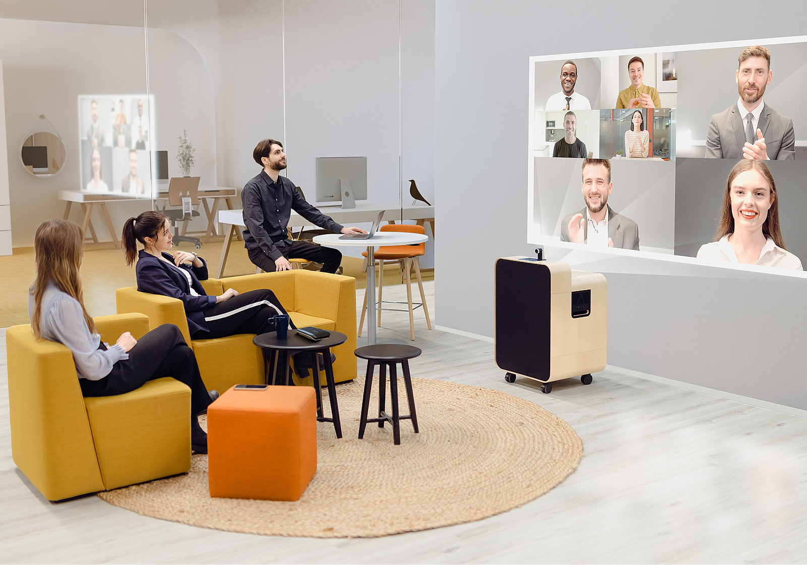 A group of employees sit in golden yellow chair facing a wall with the Artome M10 projecting a video conference call with multiple people.