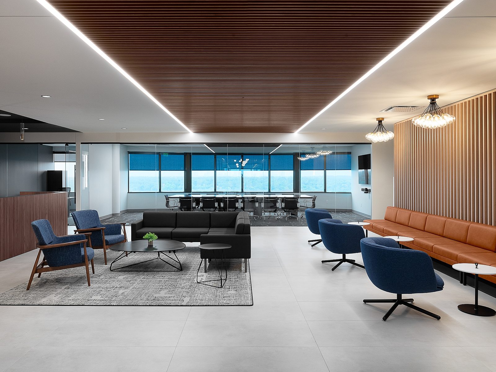 DiPasquale Moore collaboration/event space featuring slatted wood finishes, modern lighting, leather banquette seating w/ small tables and a lounge setting