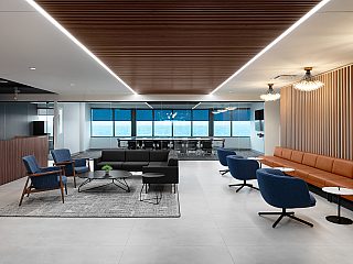 DiPasquale Moore collaboration/event space featuring slatted wood finishes, modern lighting, leather banquette seating w/ small tables and a lounge setting