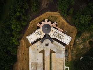Aerial view of the Eastern Shawnee Tribe building and grounds.  Resembles an arrow, with long parking lot and slight v-shaped building at upper end.