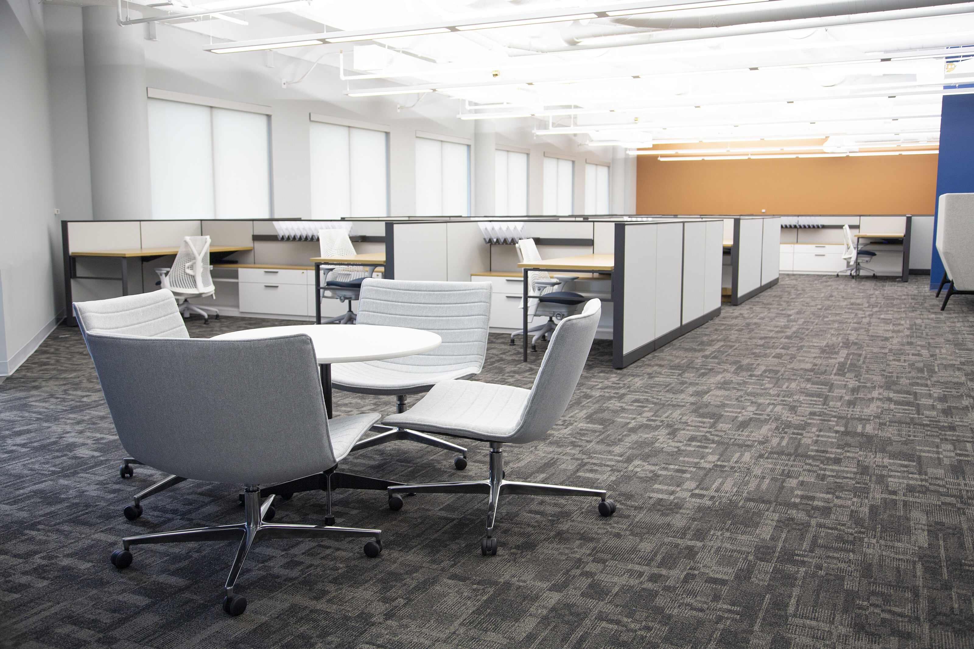 My Freight World - open workstation area with small round conference table with light grey chairs with casters